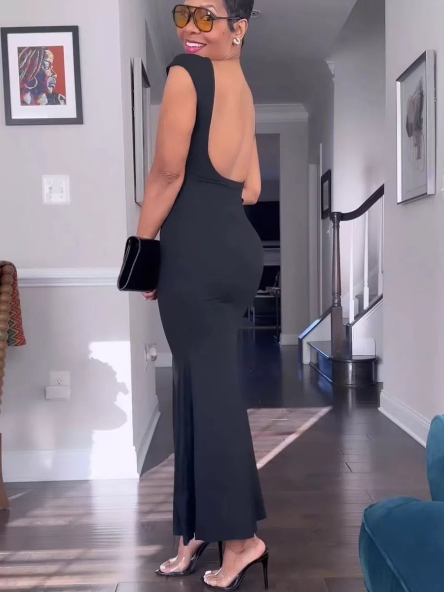 Black backless maxi gown with cap sleeves and a boat neckline.