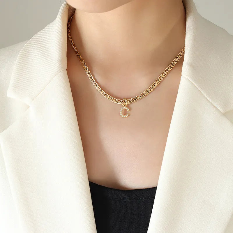 Gold chain necklace with a zircon-set initial "C" pendant