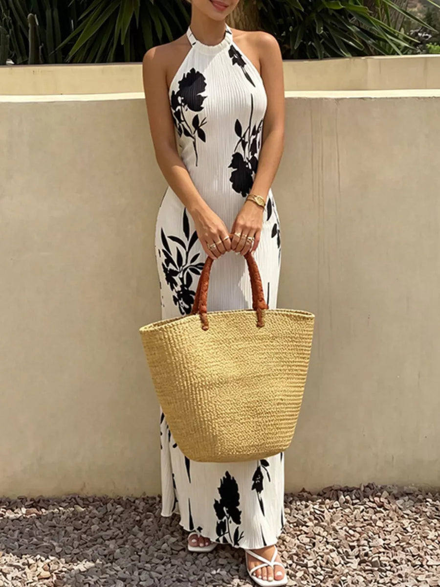 White floral print halter maxi dress with a-line cut and button details.