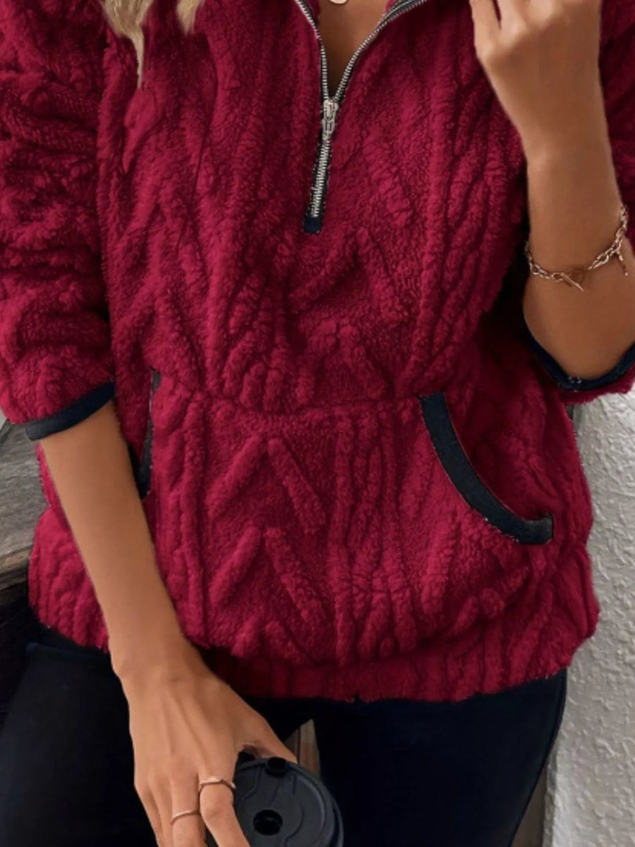 Burgundy sherpa half zip sweatshirt with chevron pattern and front pocket