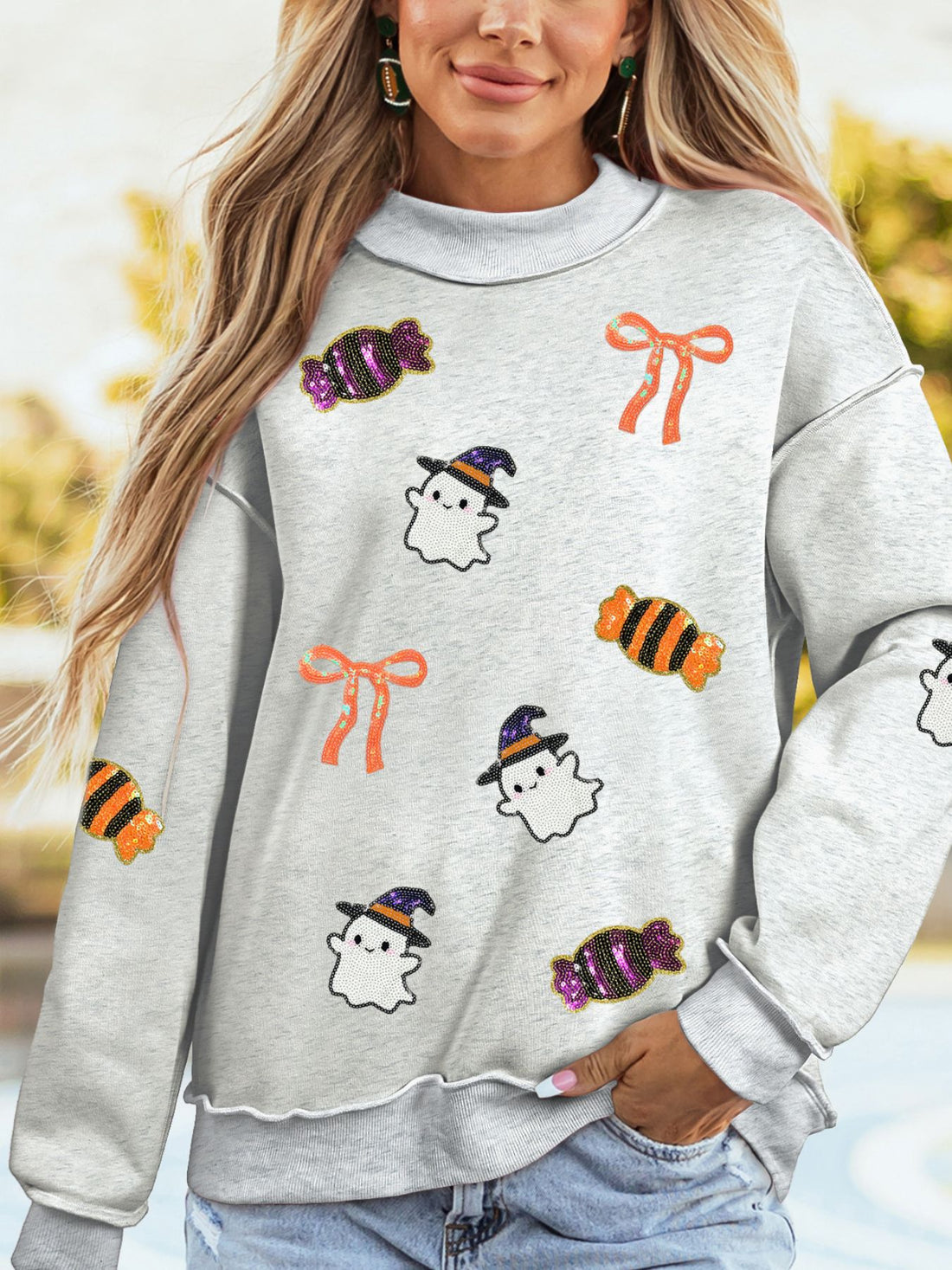 light gray sweatshirt with graphic and mock neck