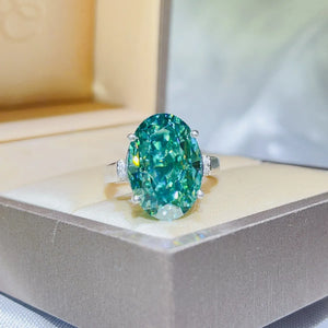 Emerald cut turquoise moissanite cocktail ring with diamond accents.