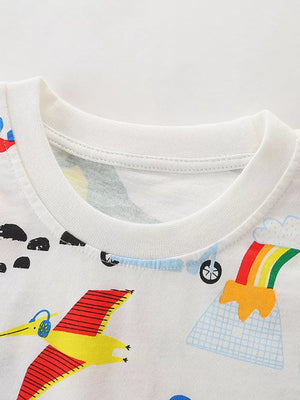 White cotton toddler tee with playful dinosaur and rainbow print.
