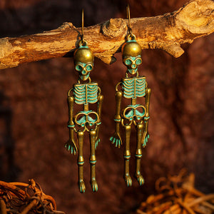 Skeleton drop earrings in antique gold with teal accents, featuring full articulated bodies.