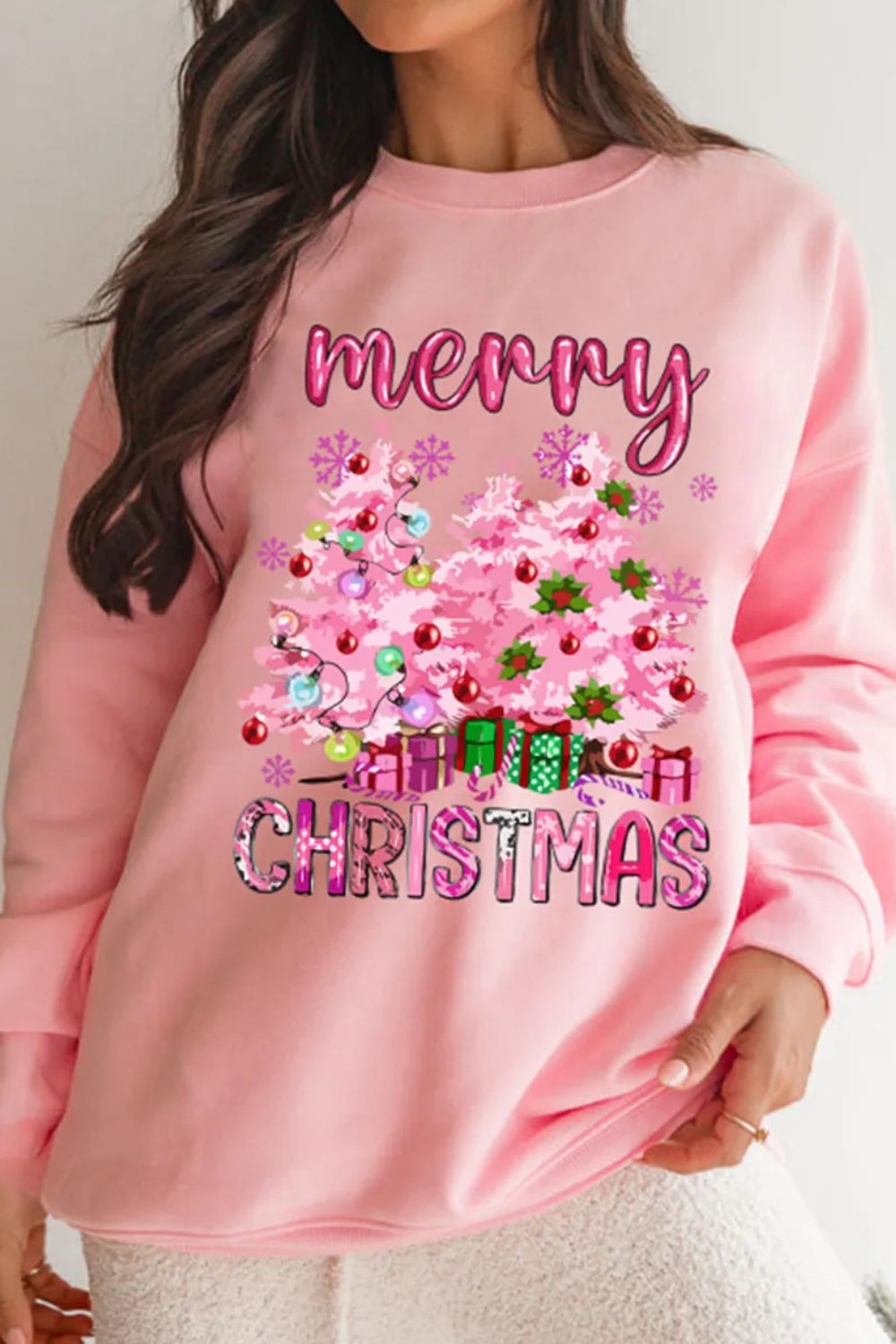 Pink Christmas graphic sweatshirt with trees and gifts, crewneck, long sleeve.