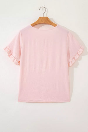 Blush pink polyester short sleeve blouse with ruffle trim detail.