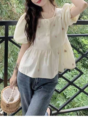 Polyester content is at least 90% and less than 95% blouse in cream with relaxed silhouette