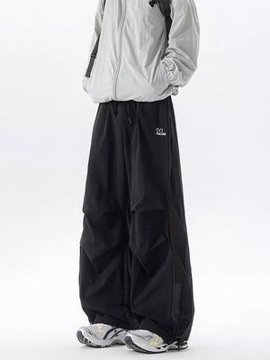 Black cargo sweatpants with adjustable waist and mesh panel detail