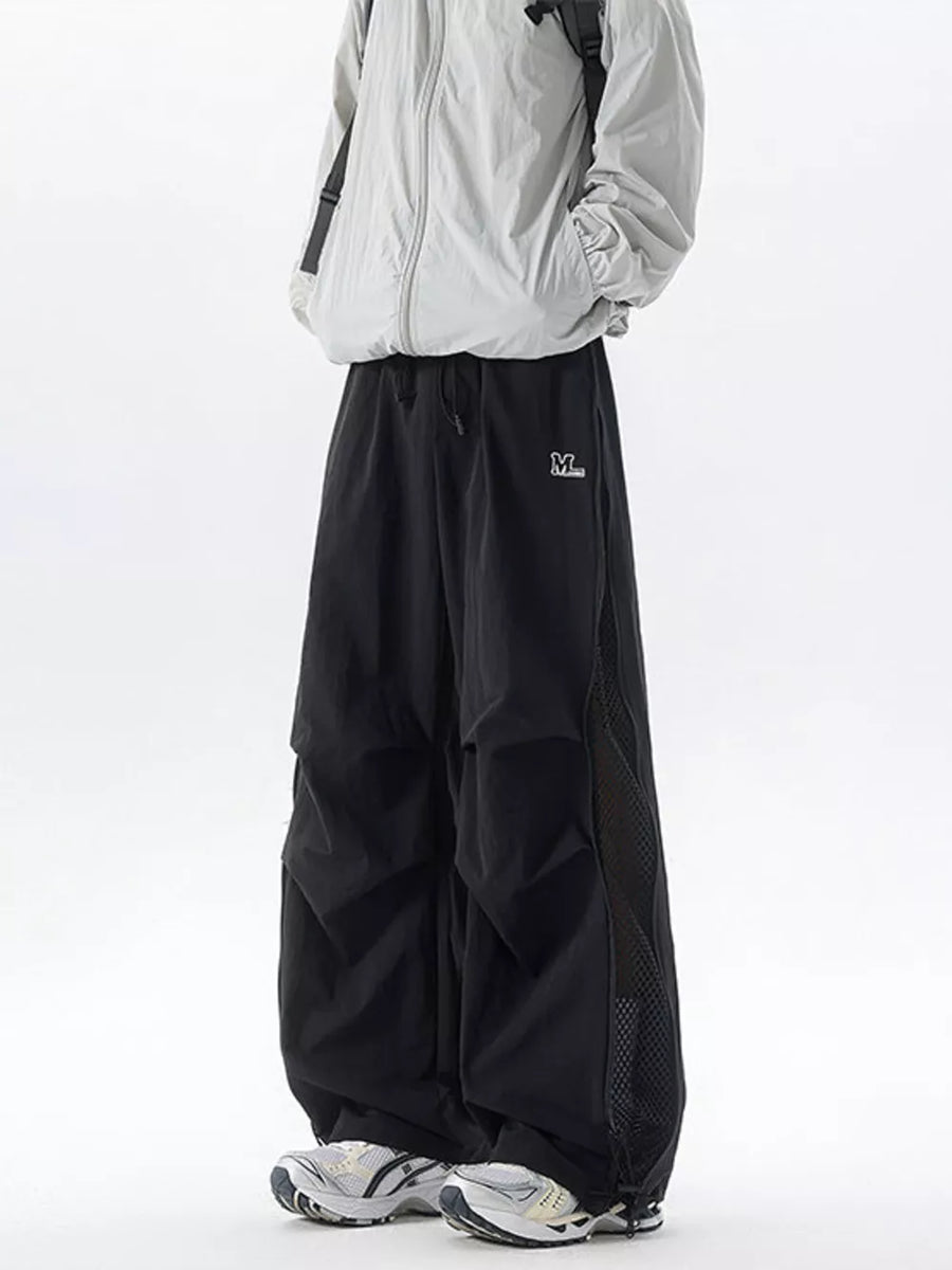Black cargo sweatpants with adjustable waist and mesh panel detail