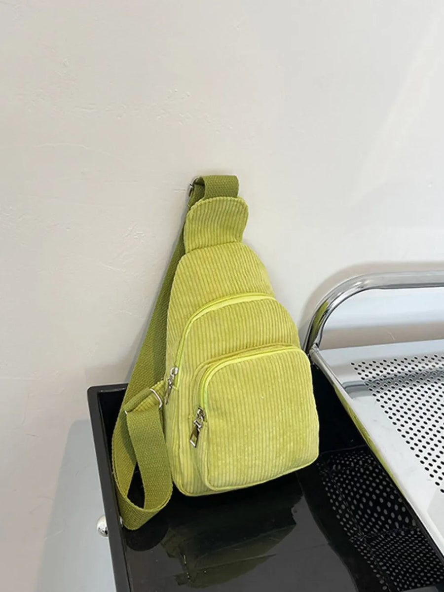 Yellow green corduroy sling bag with zip pockets and adjustable strap