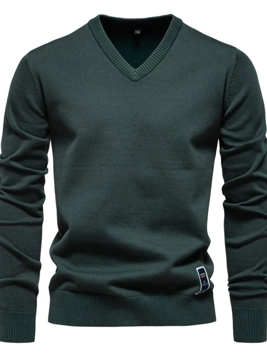 Essential V-neck ribbed knit sweater in Peacock Blue with a ribbed hem and cuffs.