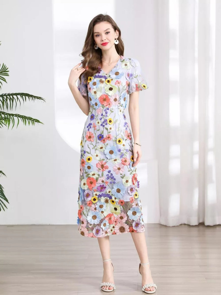 Floral embroidered midi dress with V-neck, short flutter sleeves, and sheer overlay.