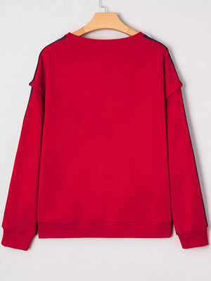 Red sweatshirt with varsity stripe detail on sleeves and neckline