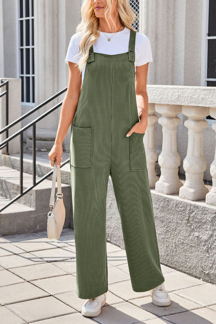 Moss green striped denim overalls with patch pockets and wide legs.
