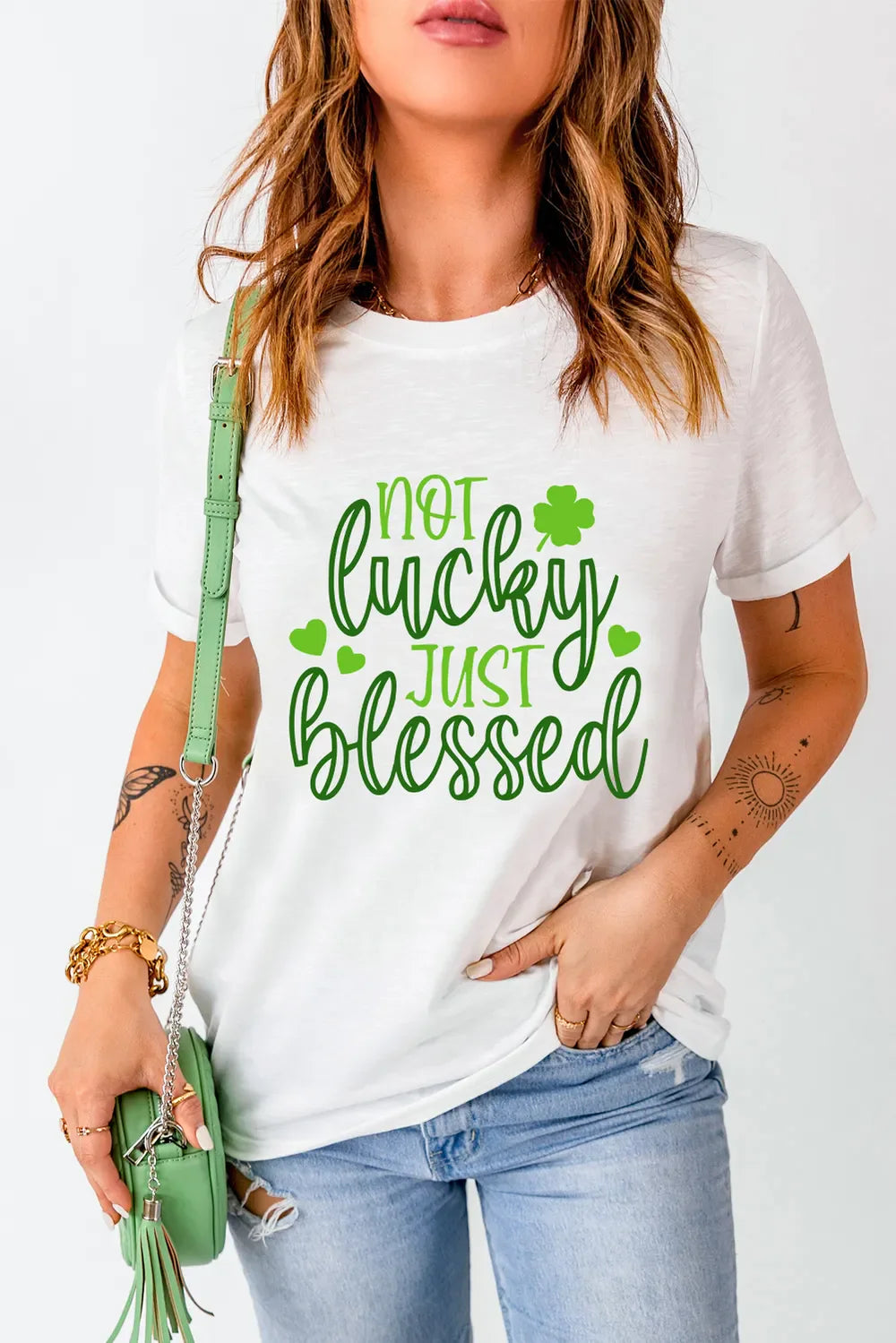 White crew neck t-shirt with green text that says Not Lucky Just Blessed and shamrock graphics.