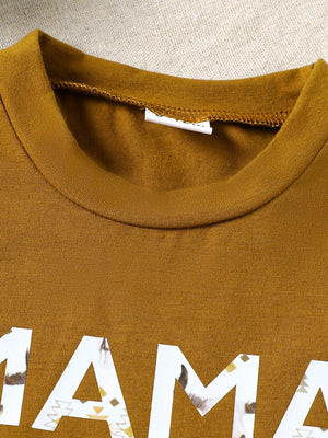 Caramel cotton blend graphic tee with "mama" text and tribal pattern detail.