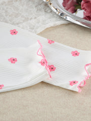 White knit lounge set with pink floral print and frill trim detail.
