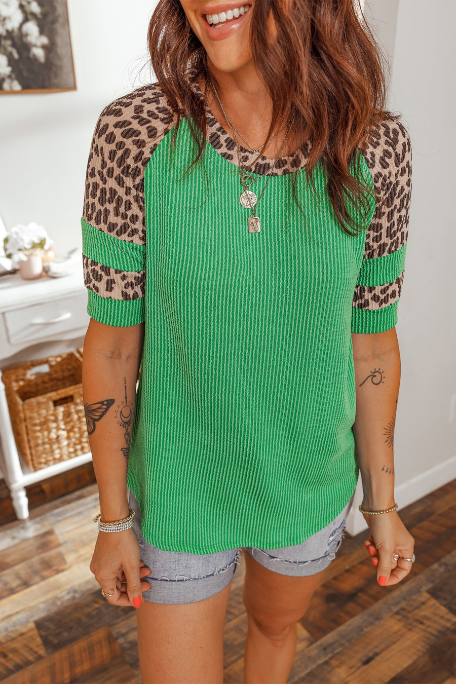 Leopard print patchwork tunic tee with green ribbed body and short sleeves.