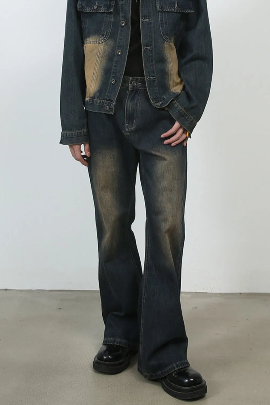 Dark wash denim flare jeans with vintage fading and a baggy fit.