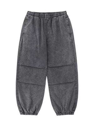 Grey relaxed fit cargo pants with elastic waistband and cuffs, and paneled legs.