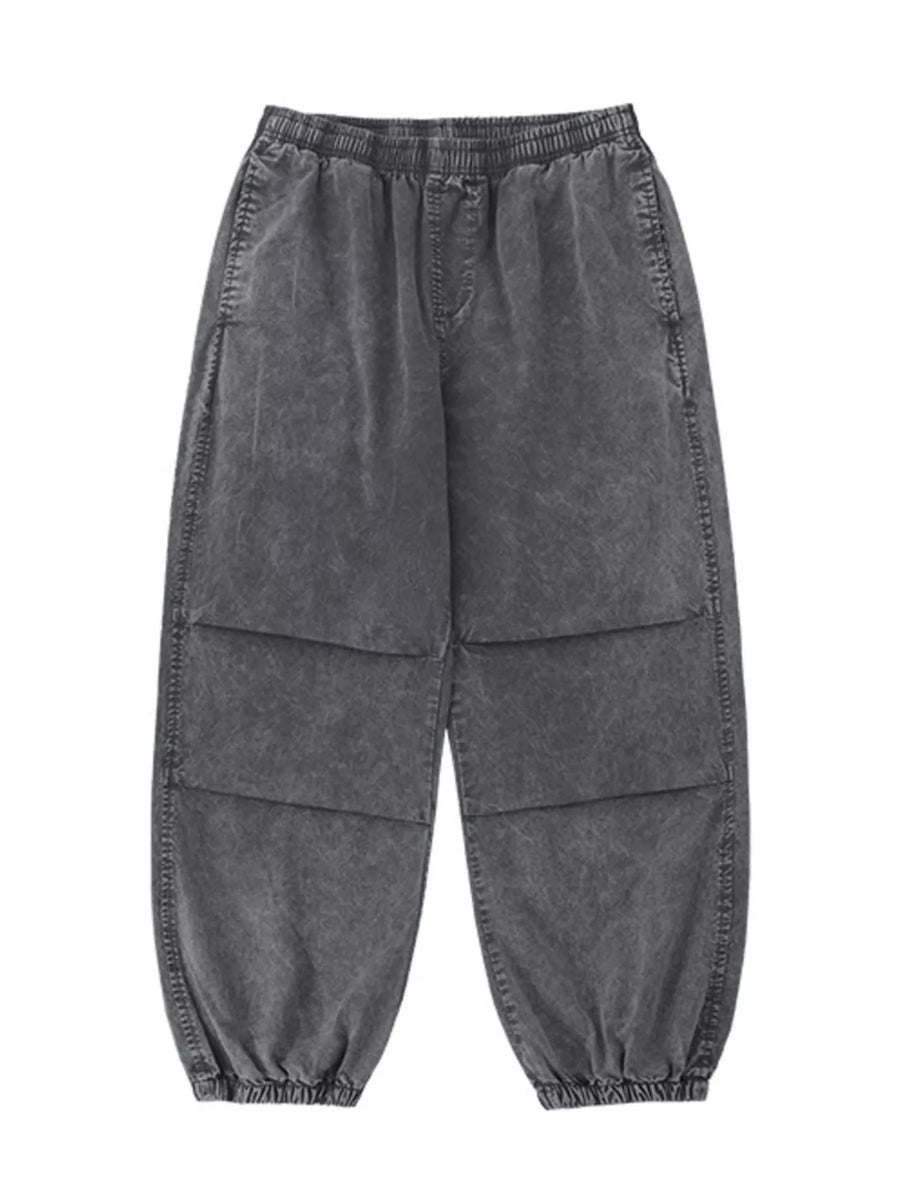 Grey relaxed fit cargo pants with elastic waistband and cuffs, and paneled legs.