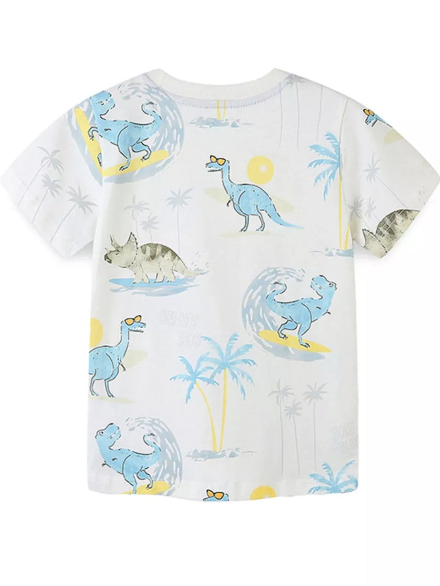 Toddler white t-shirt with blue dinosaurs surfing and palm trees.