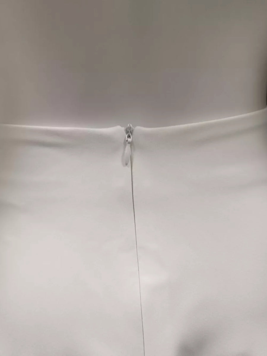 White skirt with a silver zipper closure and subtle seam detail.
