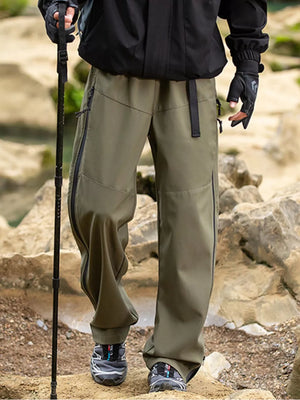 Olive brown utility-inspired men's sweatpants with wide legs and zippered pockets.