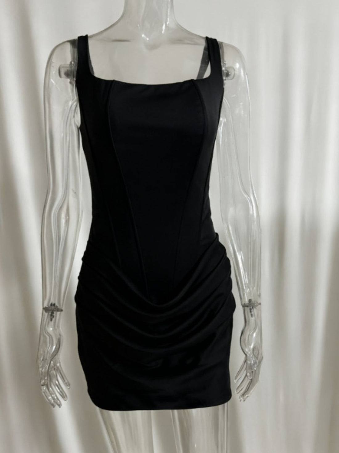 Black sleeveless mini dress with square neckline and ruched detail