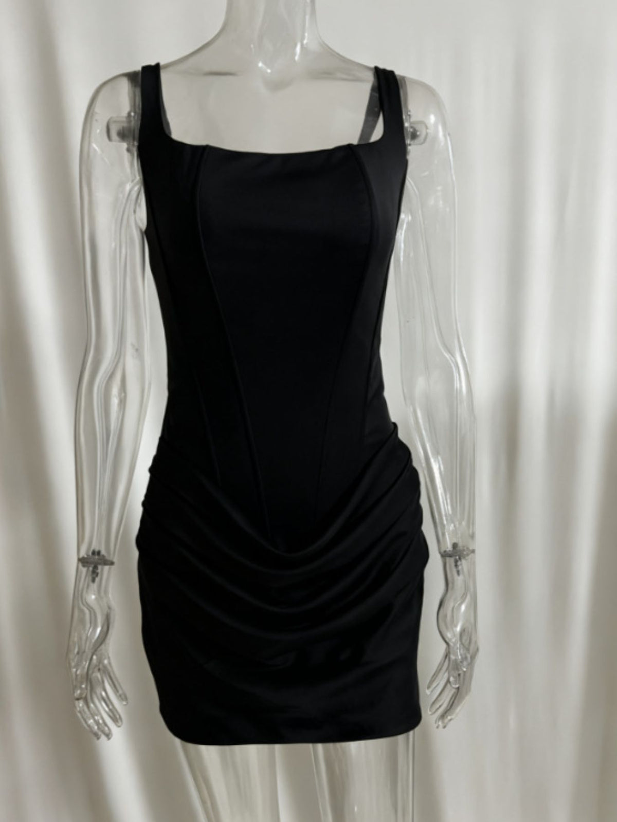 Black sleeveless mini dress with square neckline and ruched detail
