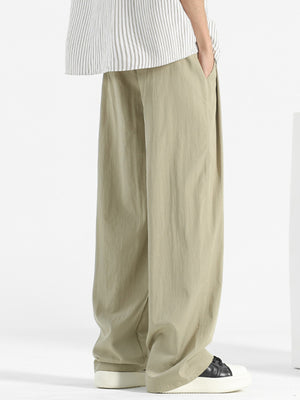 Plus-size sage sweatpants with loose fit and elastic waistband, shown from the side.