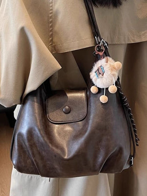 Slouchy coffee brown pu leather shoulder bag with button flap pocket and fluffy charm