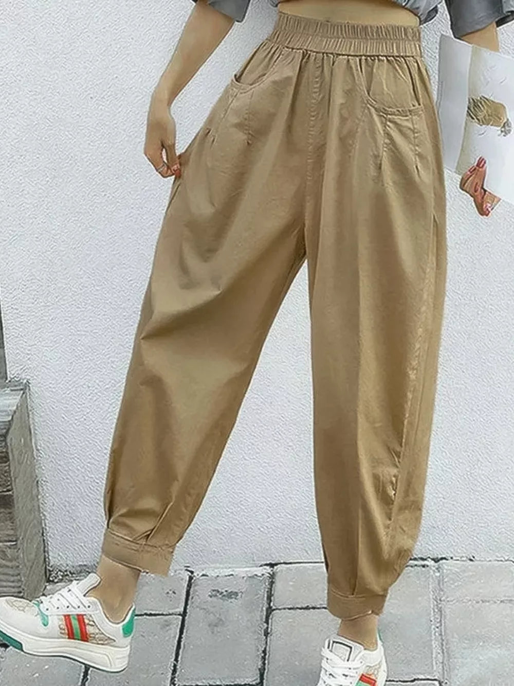 Khaki relaxed fit harem joggers with elastic waist and pockets.