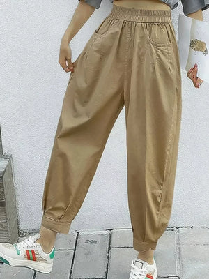Khaki relaxed fit harem joggers with elastic waist and pockets.