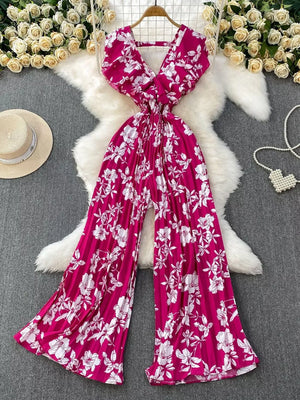 Rose Red floral pleated wide-leg romper with V-neck and wide sleeves.