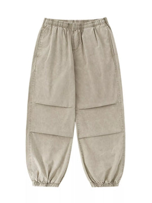 Khaki relaxed fit cargo pants with elastic waist and cuffs, and paneled legs.