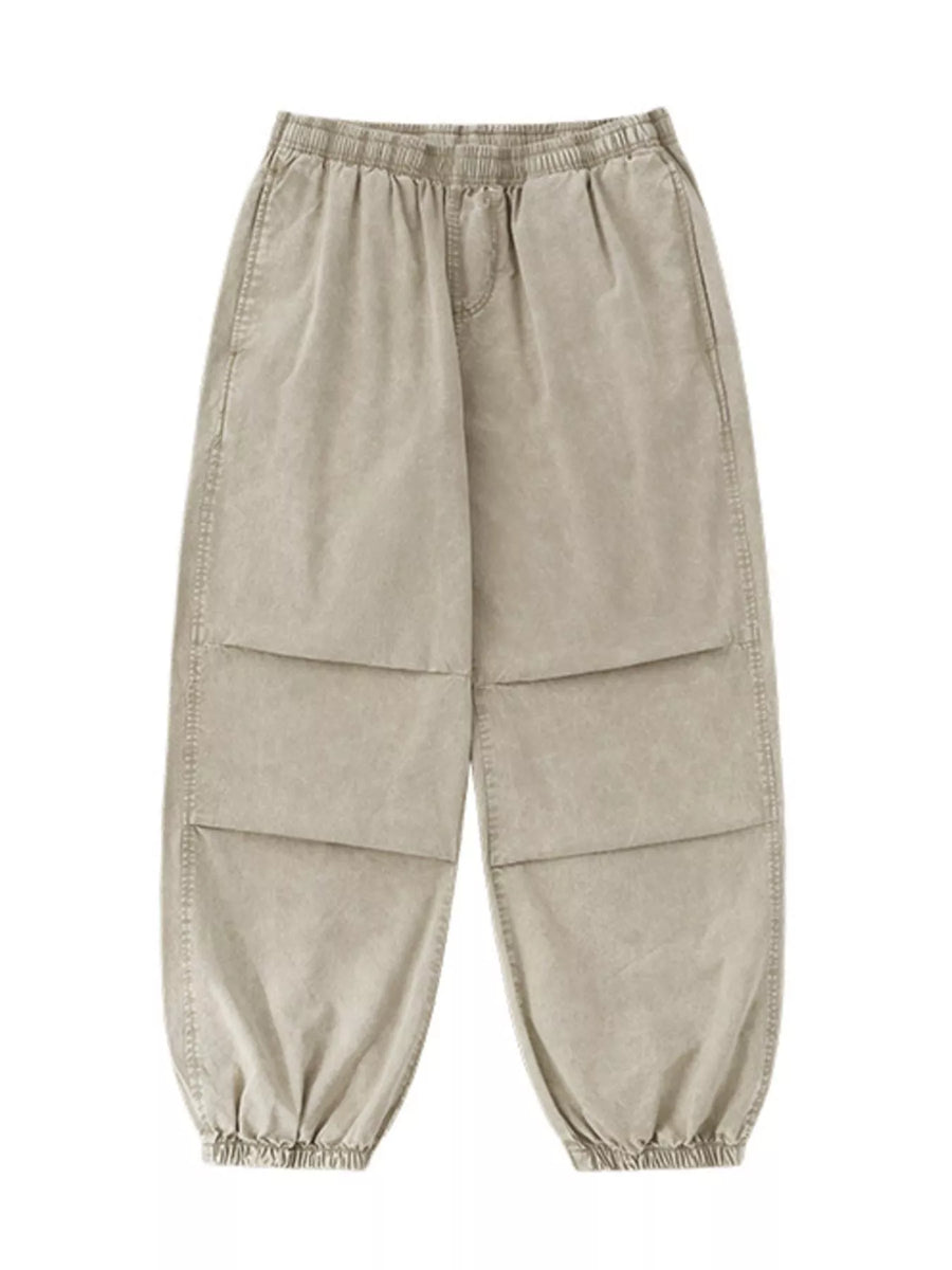 Khaki relaxed fit cargo pants with elastic waist and cuffs, and paneled legs.