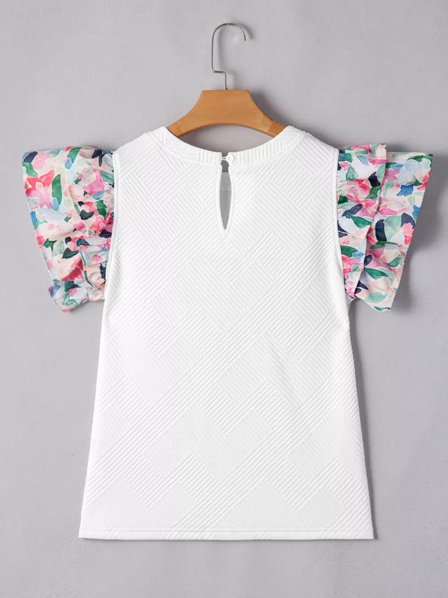 White geometric knit top with floral ruffled sleeves and keyhole back detail.