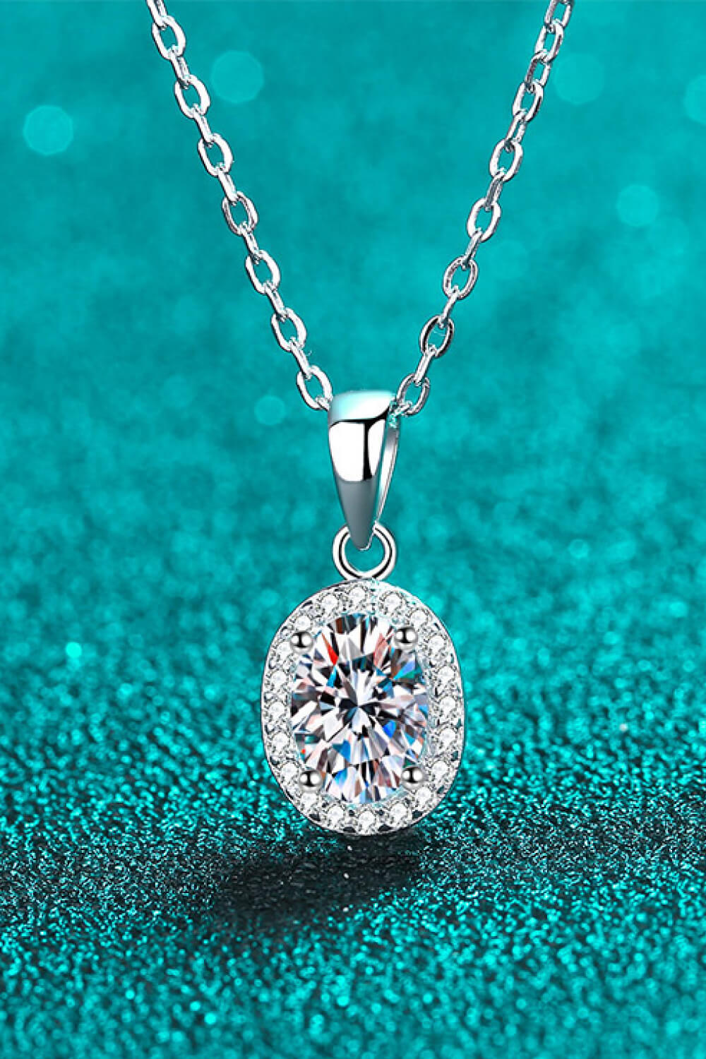 Silver halo moissanite pendant necklace with oval center stone and diamond accents on sterling silver chain