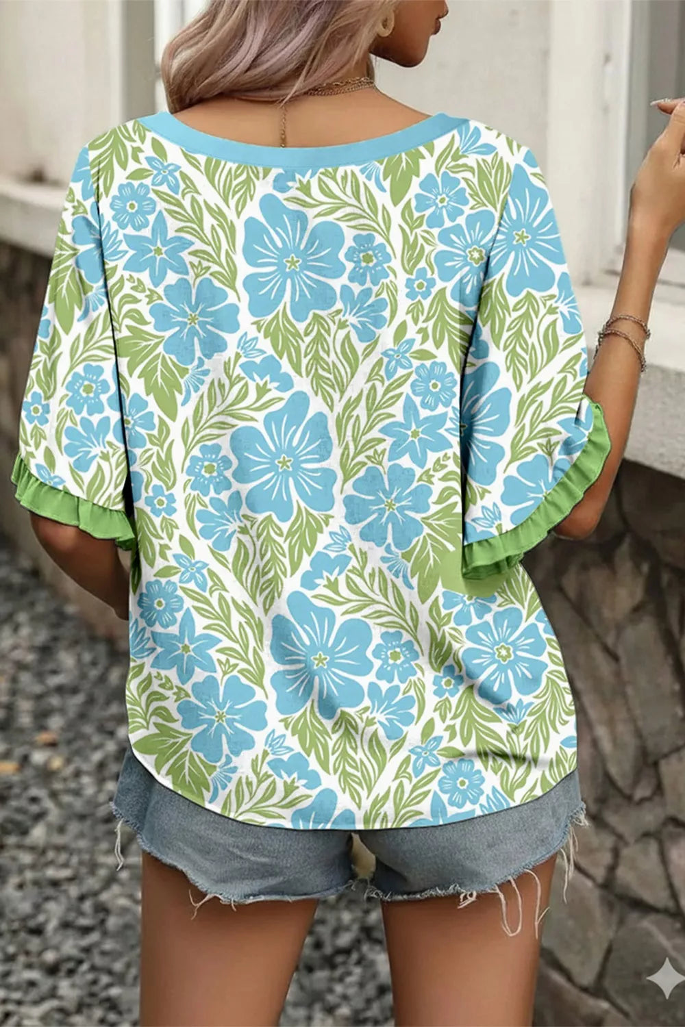 Floral ruffled half sleeve maternity blouse with blue flowers and green leaves pattern.