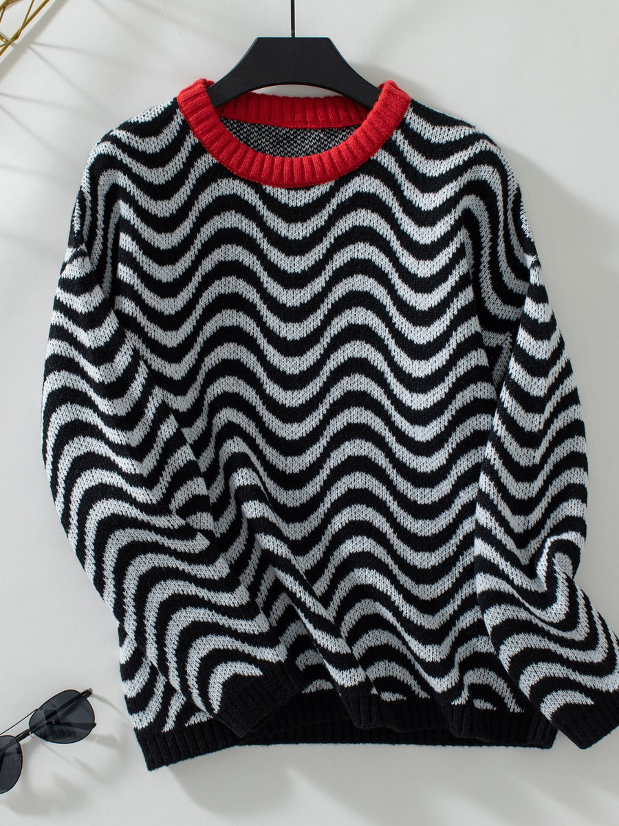 Black and white wavy stripe knit sweater with a red contrast collar.