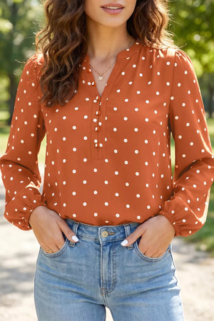 Charming polka dot V-neck shirt with decorative buttons and long sleeves.