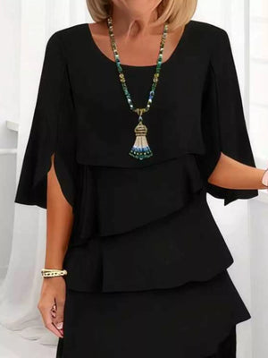 Black ruffled tiered dress with flutter sleeves and a scoop neckline.