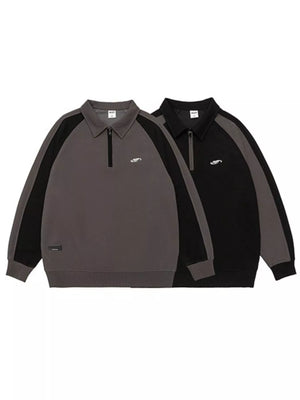 Plus-size raglan quarter zip sweatshirt in dark gray and black with contrast stitching and embroidered logo.