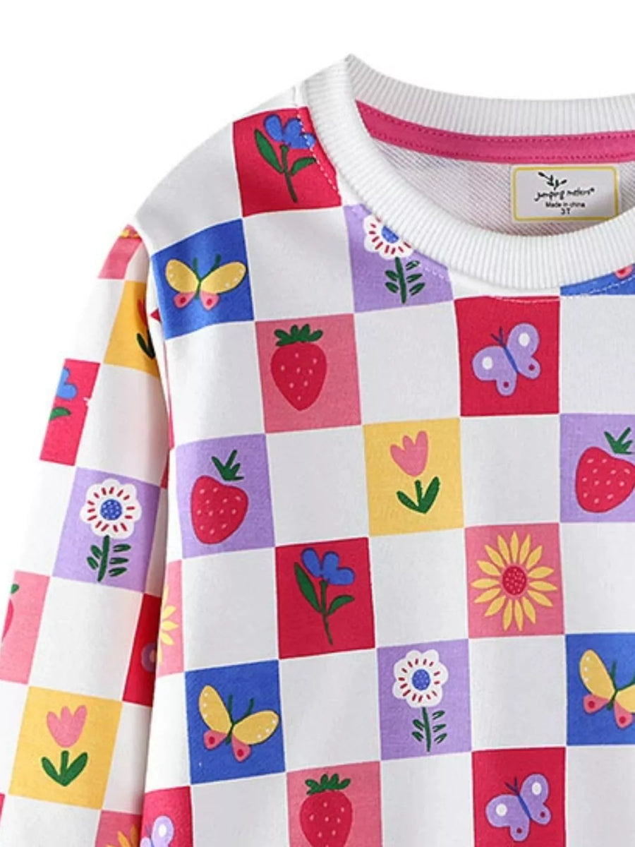 Baby sweatshirt with multicolor checkered pattern of strawberries, flowers, and butterflies.