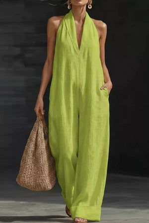 Lime halter-neck pocketed jumpsuit with wide legs and a deep V-neck.