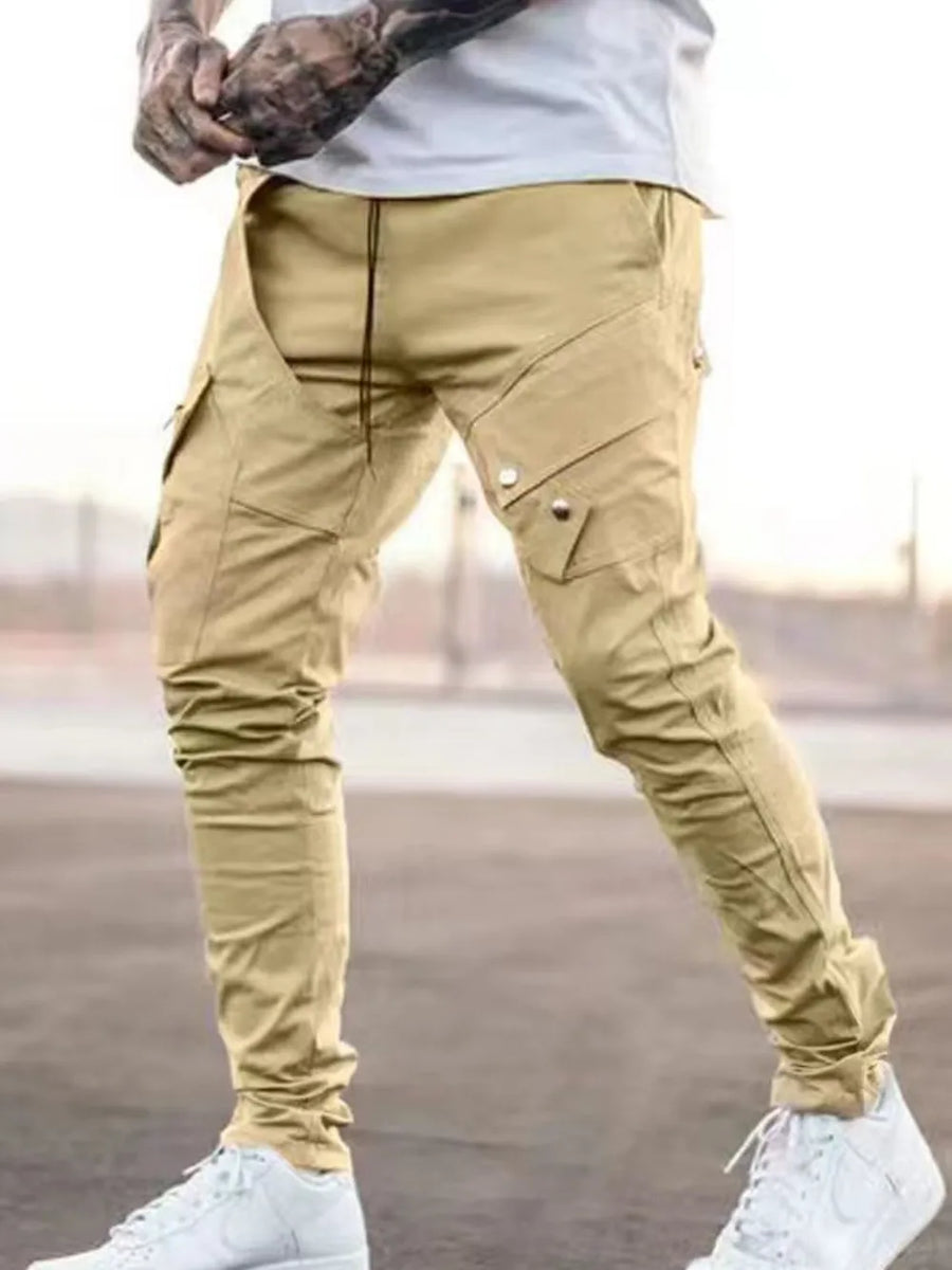 Tan zip pocket slim cargo trousers with multiple pockets and a drawstring waist.