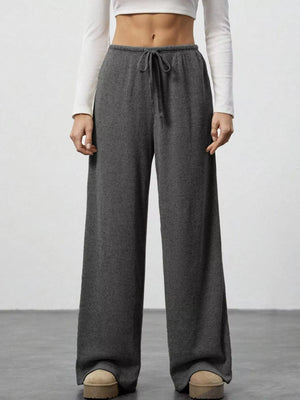 Dark gray ribbed wide-leg pants with drawstring waist and relaxed fit.