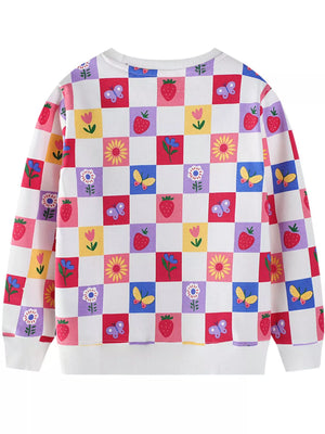 Baby sweatshirt with multicolor checkered pattern of strawberries, butterflies, and flowers.