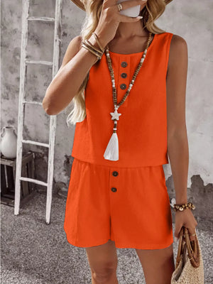 Orange cotton two-piece set with decorative buttons and tassel necklace